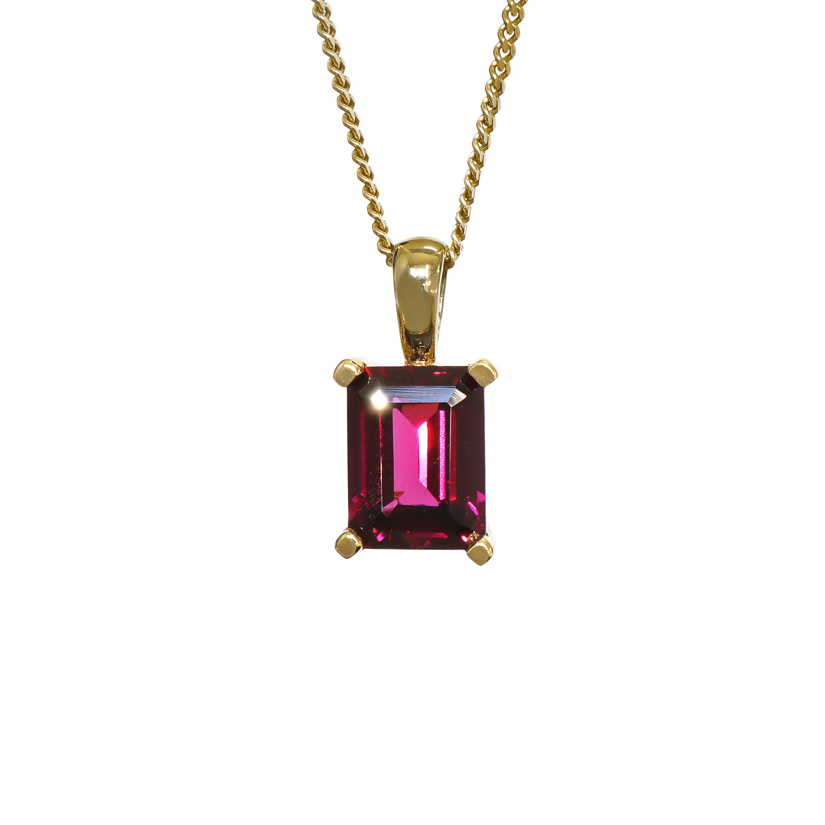 A product photo of a 8x6mm Rectangular Rhodalite Pendant in 9k Yellow Gold suspended against a white background. The impressively large and deeply-coloured stone is contrasted by its overall minimalistic design, 4 simple golden claws holding the gem in place. It is suspended by a simple gold chain. The rhodalite reflects warm, pinky purple hues across its multi-faceted edges.