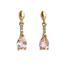 A product photo of 7x5mm Pear Morganite & Diamond Earrings in 9k Yellow Gold sitting on a plain white background. A golden strip connects the morganites to the studs, each strip adorned with 3 diamonds each. The morganites reflect light pinky hues across their multi-faceted edges.