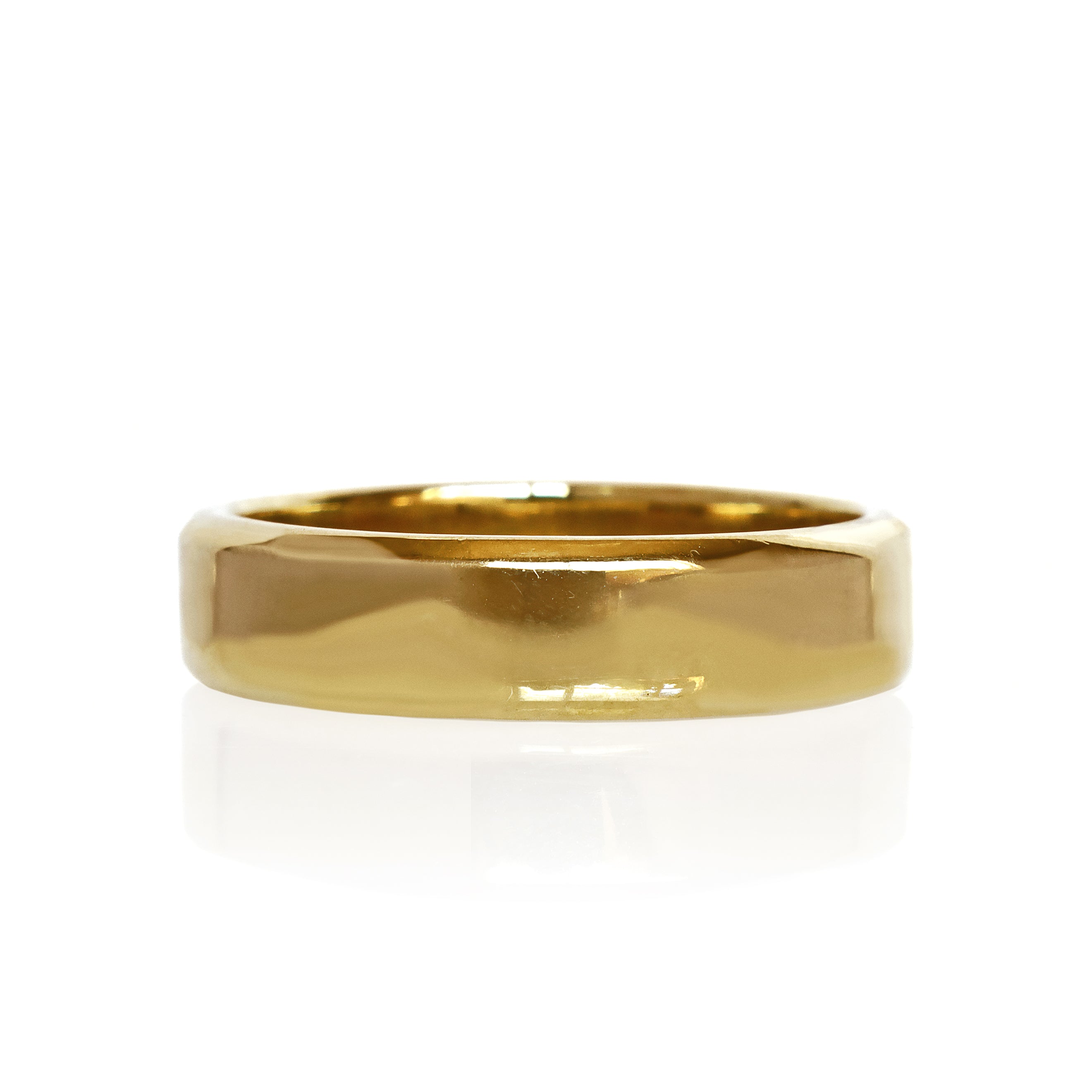 A product photo of a mens' ring made of 9k yellow gold. The band is 5mm tall and flat, and has bold squared edges.