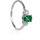 A product photo of a uniquely elegant tsavorite and duo diamond ring in solid 9k white gold on a white background. The deep, verdant-green tsavorite centre stone is held in place by 4 claws and reflects light off of its many facets, while the bezel-set diamonds are framed by a solid layer of white gold. The green gemstone colour would be a good emerald substitute.