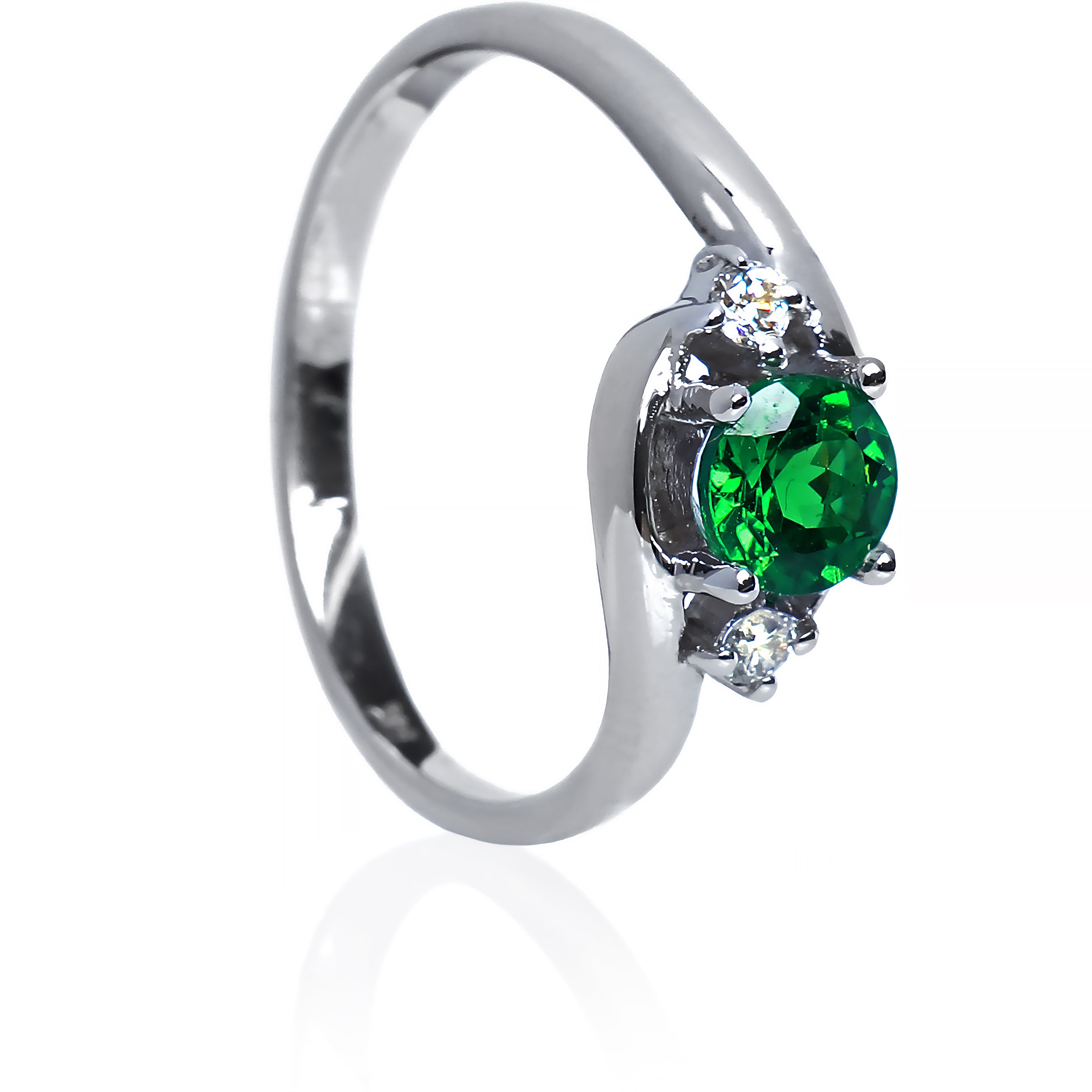 A product photo of a mystical tsavorite and diamond fantasy ring in solid 9k white gold on a white background. The deep, verdant-green tsavorite is held in place by 4 claws and reflects light off of its many facets, while the diamonds on either side are held by 3 each. The smooth white gold band curves elegantly, meeting at the top and bottom of the tsavorite and diamond arrangement. The green gemstone colour be a good emerald substitute.