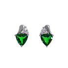 A product photo of a pair of white gold tsavorite earrings sitting against a white background. The trilliant-shaped gemstones are complimented by a trio of white diamonds atop each stone, hugged by a teardrop-shaped frame of white gold. The green gemstone colours make these earrings a good alternative or substitute for emerald.