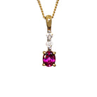 A product photo of a 9k yellow gold diamond and rhodalite garnet pendant supended by a chain against a white background. The pendant is slim and delicate, consisting of 2 0.04ct round white diamonds linked together by golden claw settings, ending off with a gorgeous, oval-shaped plum rhodalite jewel as the main attraction.