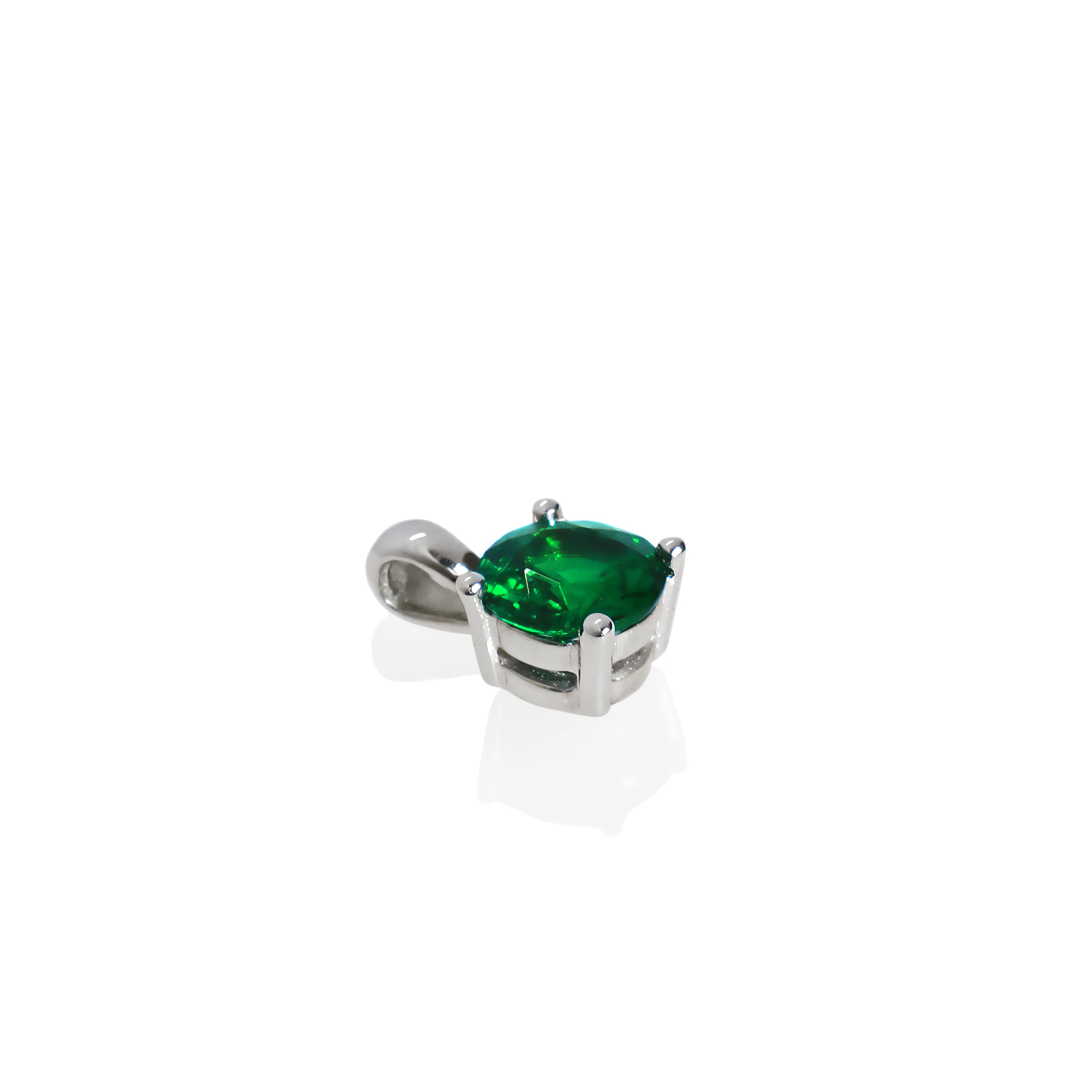 A product photo of a white gold tsavorite pendant suspended by a chain against a white background. The round stone is held in place by 4 small claws, and reflects electric green and verdant colours from its many edges.