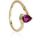 A product photo of a yellow gold grape garnet ring sitting against a white background. The gold band is plain and smooth, and curves to meet at the top and bottom of a large, 7x5mm pear shaped grape garnet centre stone - holding it in place.