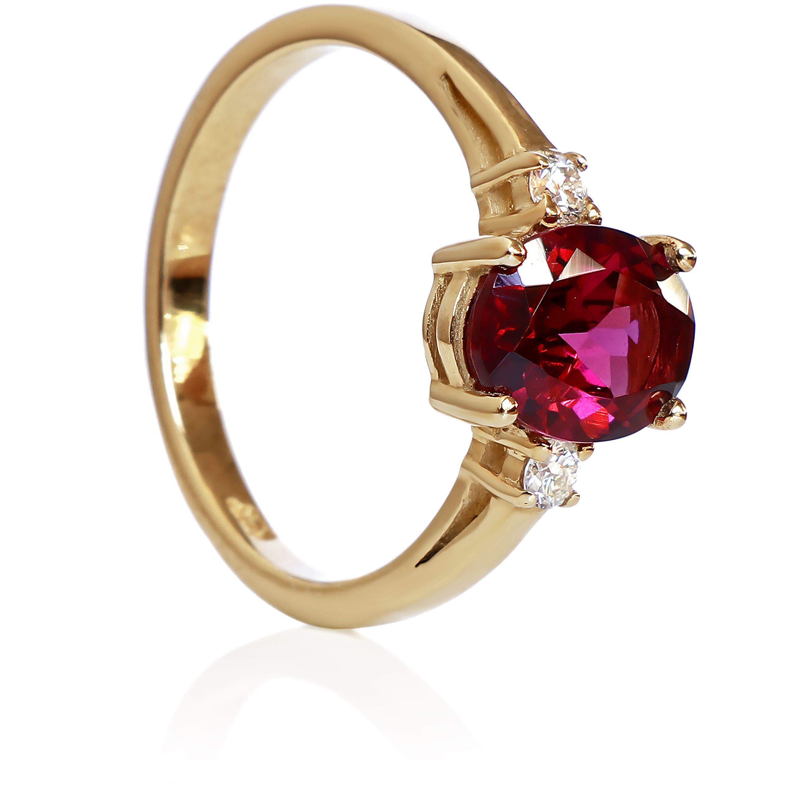 A product photo of a dainty and elegant yellow gold ring with a stunning trio of rhodalite and diamonds sitting against a white background. The largest of the stones sits in the centre, an oval rhodalite - hugged by two smaller circular white diamonds on either side.