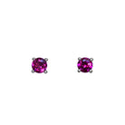 A product photo of two white gold stud earrings sitting on a white background. Held in place by 4 silver claws each are two dazzling round-cut purple grape garnet gemstones, reflecting shades of cool magenta light from their many edges.