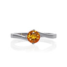 A product photo of a curved-band silver solitaire ring with an nright orange citrine centre stone sitting on a white background.