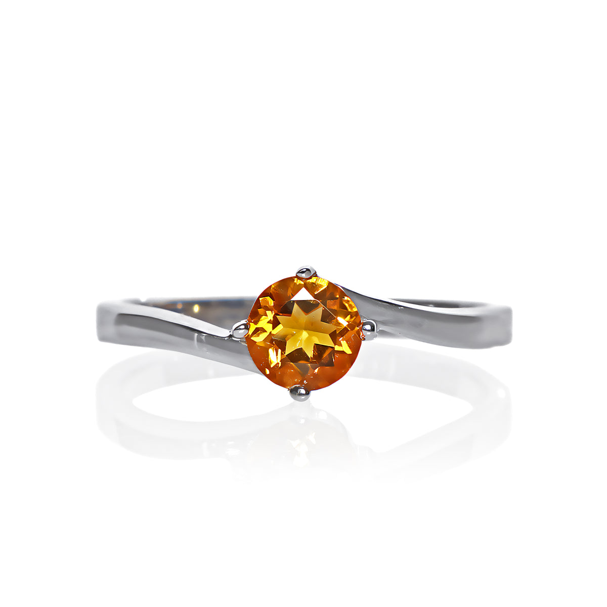 A product photo of a curved-band silver solitaire ring with an nright orange citrine centre stone sitting on a white background.