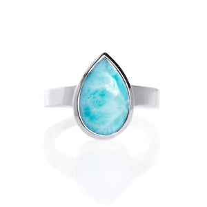 
            
                Load image into Gallery viewer, A product photo of a silver Larimar ring on a white background. The band is tall and thick. The 14x9mm pear cabochon Larimar stone has dappled white and light blue patterning, similar to water reflections at the bottom of a pool. The stone is set in a thick silver bezel setting.
            
        