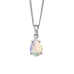 A product photo of a silver Ethiopian Rainbow Opal pendant suspended by a silver chain over a white background.The semi-opaque, light-toned opal reflects rainbow-coloured fire from its faceted edges.