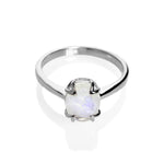 A product photo of a silver moonstone solitaire ring on a white background. The 9x7mm oval faceted moonstone is uniquely translucent, with an indigo sheen and milky inclusions. The stone is held in place with 4 v-shaped silver claws.