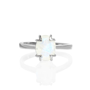 
            
                Load image into Gallery viewer, A product photo of a silver moonstone solitaire ring on a white background. The 9x7mm oval faceted moonstone is uniquely translucent, with an indigo sheen and milky inclusions. The stone is held in place with 4 v-shaped silver claws.
            
        