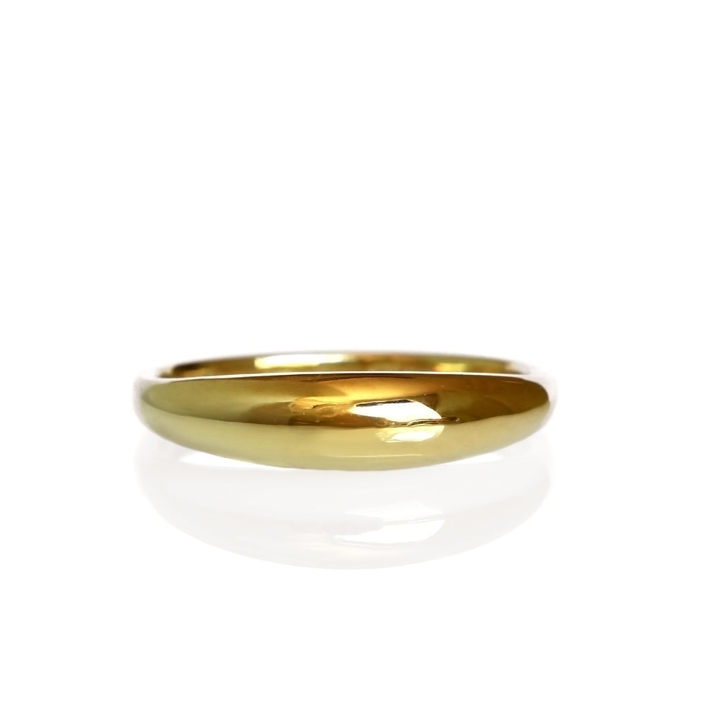 A product photo of a mens' dome ring made of 9k yellow gold on a white background. The face of the ring is a rounded and the widest part of the ring, and slowly transitions to a slightly thinner rounded gold band further along each side towards the back.