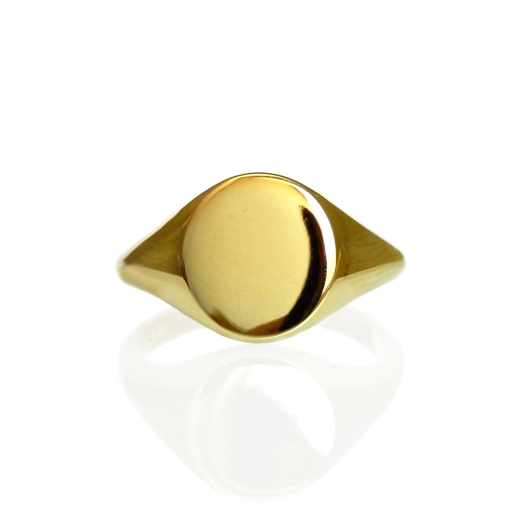 A product photo of a mens' signet ring made of 9k yellow gold on a white background. The face of the ring is a 9x7mm flat ovoid that transitions to a thick rounded band.
