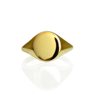 
            
                Load image into Gallery viewer, A product photo of a mens&amp;#39; signet ring made of 9k yellow gold on a white background. The face of the ring is a 9x7mm flat ovoid that transitions to a thick rounded band.
            
        
