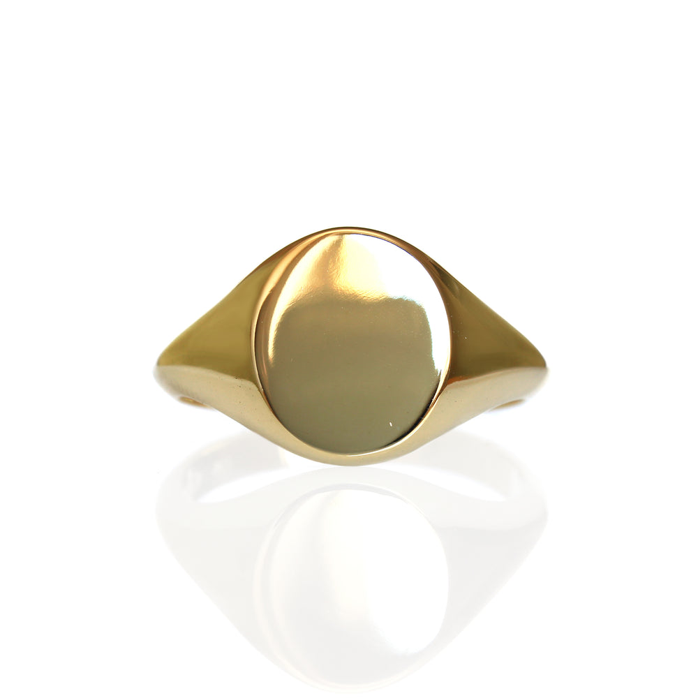A product photo of a mens' signet ring made of 9k yellow gold on a white background. The face of the ring is an 12x10mm flat ovoid that transitions to a thick rounded band.