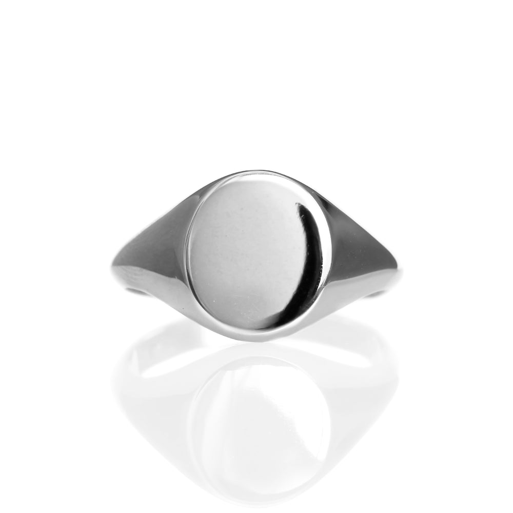 
            
                Load image into Gallery viewer, A product photo of a mens&amp;#39; signet ring made of 9k white gold on a white background. The face of the ring is an 12x10mm flat ovoid that transitions to a thick rounded band.
            
        