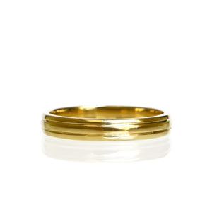 A product photo of a mens' ring made of 9k yellow gold on a white background. The band is 4mm tall and detailed with two polished grooves.
