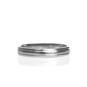 A product photo of a mens' ring made of 9k white gold on a white background. The band is 4mm tall and detailed with two polished grooves.