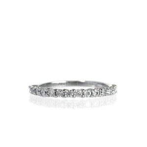 A product photo of a white gold eternity band with 15 moissanite stones embedded along its length on a white background.
