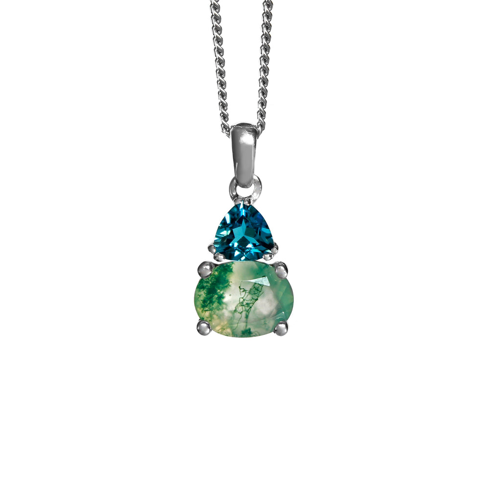 A product photo of a silver moss agate and moissanite necklace suspended against a white background. The horizontally-oriented moss agate stone is held in place by 4 pairs of claws at its top and bottom, with a 5mm London Blue Topaz gem connecting the stone to the rest of the pendant. It is suspended by a simple silver chain.