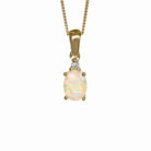 A product photo of a yellow gold hydrophane Ethiopian rainbow opal and diamond necklace sitting against a white background. The beautifully unique rainbow opal stone is held in place by 4 pairs of claws at its top and bottom, with a single white diamond connecting the stone to the rest of the pendant. It is suspended by a simple yellow gold chain.