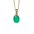 A product photo of a 9x7mm Oval green onyx Pendant in 9k Yellow Gold suspended against a white background. The impressively large and deeply-coloured oval-cut stone is contrasted by its overall minimalistic design, 4 simple golden claws holding the gem in place. It is suspended by a simple gold chain.