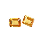 A pair of 10x8mm octagonal/emerald-cut citrine gemstones on a white background. The stones are perfectly-matched in both size and golden yellow hue, and are ideal for use in a bespoke pair of birthstone earrings, or as a gift to two people with a November birthday.