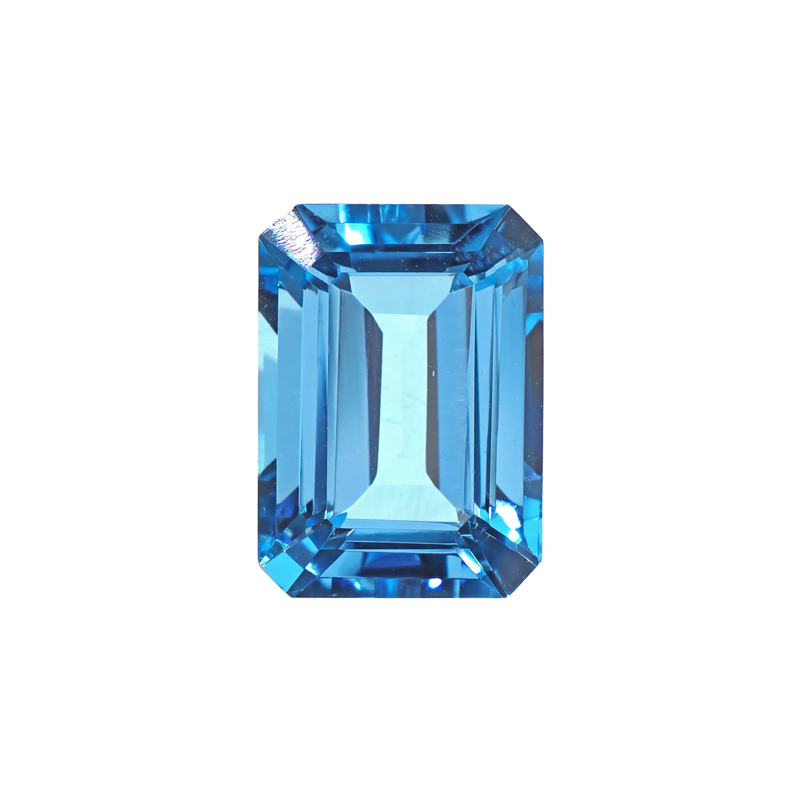 A loose 14x10mm emerald Swiss blue topaz gemstone on a white background. This brilliant, saturated blue topaz, November's birthstone, is perfect for creating custom fine jewellery: including engagement rings, cocktail rings, or a striking birthstone pendant for a loved one born in November. The size is large, but small enough for use in everyday wearable jewellery - and is not limited to statement designs.