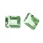 A pair of 10x8mm octagonal pastel green amethyst gemstones on a white background. The stones are perfectly-matched in both size and pale minty hue, and are ideal for use in a bespoke pair of birthstone earrings, or as a gift to two people with a February birthday.