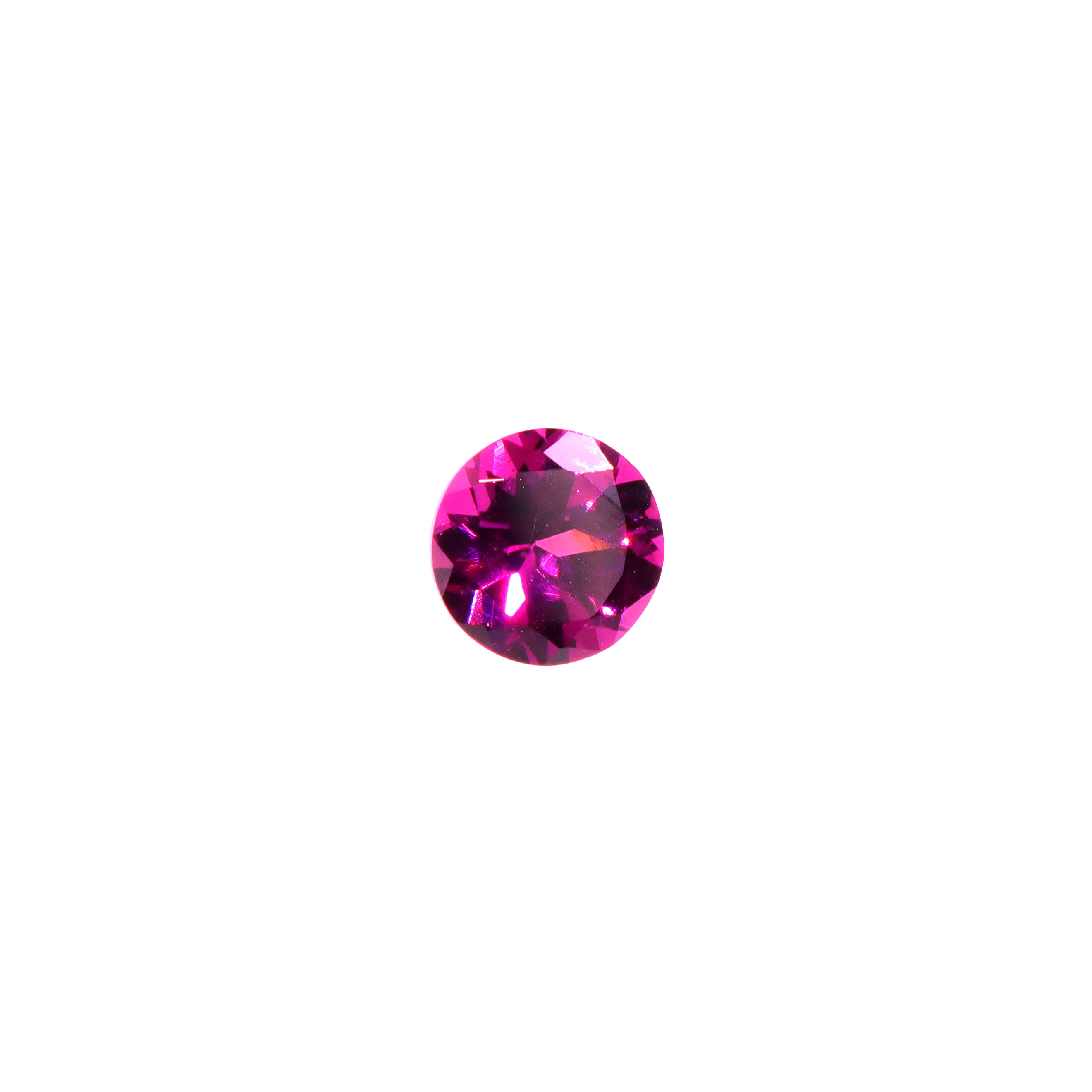 A loose 6mm round deeply-coloured grape garnet gemstone on a white background. This large, brilliantly cut natural grape garnet displays a vibrant warm purple, winelike hue, perfect for use in bespoke luxury jewellery designs. An excellent choice for a January birthstone pendant, or as an addition to one's personal gemstone collection.