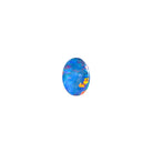 A product photo featuring a 7x5mm oval opal doublet on a white background. The stone shows a brilliant play-of-colour with distinct flashes of green and blue. Ideally suited for a delicate bespoke ring, a necklace charm or a dainty custom pendant. A beautiful and affordable October birthstone choice for elegant jewellery.