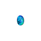 A product photo featuring a 7x5mm oval opal doublet on a white background. The stone shows a brilliant play-of-colour with distinct flashes of green and blue. Ideally suited for a delicate bespoke ring, a necklace charm or a dainty custom pendant. A beautiful and affordable October birthstone choice for elegant jewellery.