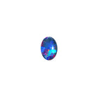 A product photo featuring a 7x5mm oval opal doublet on a white background. The stone shows a brilliant play-of-colour with distinct flashes of green and blue. Ideally suited for a delicate bespoke ring, a necklace charm or a dainty custom pendant. A beautiful and affordable October birthstone choice for elegant jewellery.