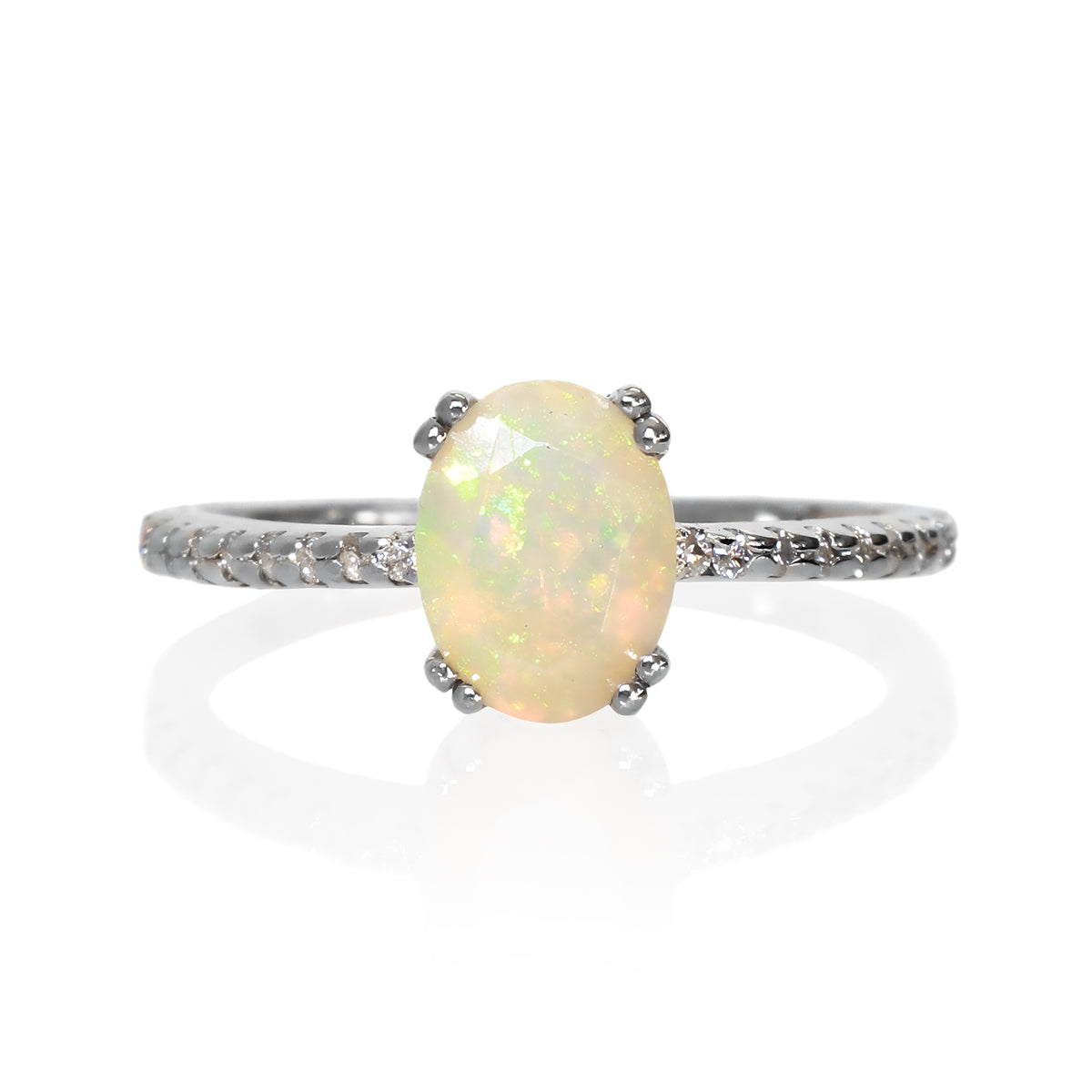 A product photo of a silver Ethiopian rainbow opal engagement ring on a white background. The ring draws from contemporary alternative styling with the 8x6mm Ethiopian rainbow opal centre stone, while calling back to the pavé engagement styles of the past with its moissanite-embedded band.