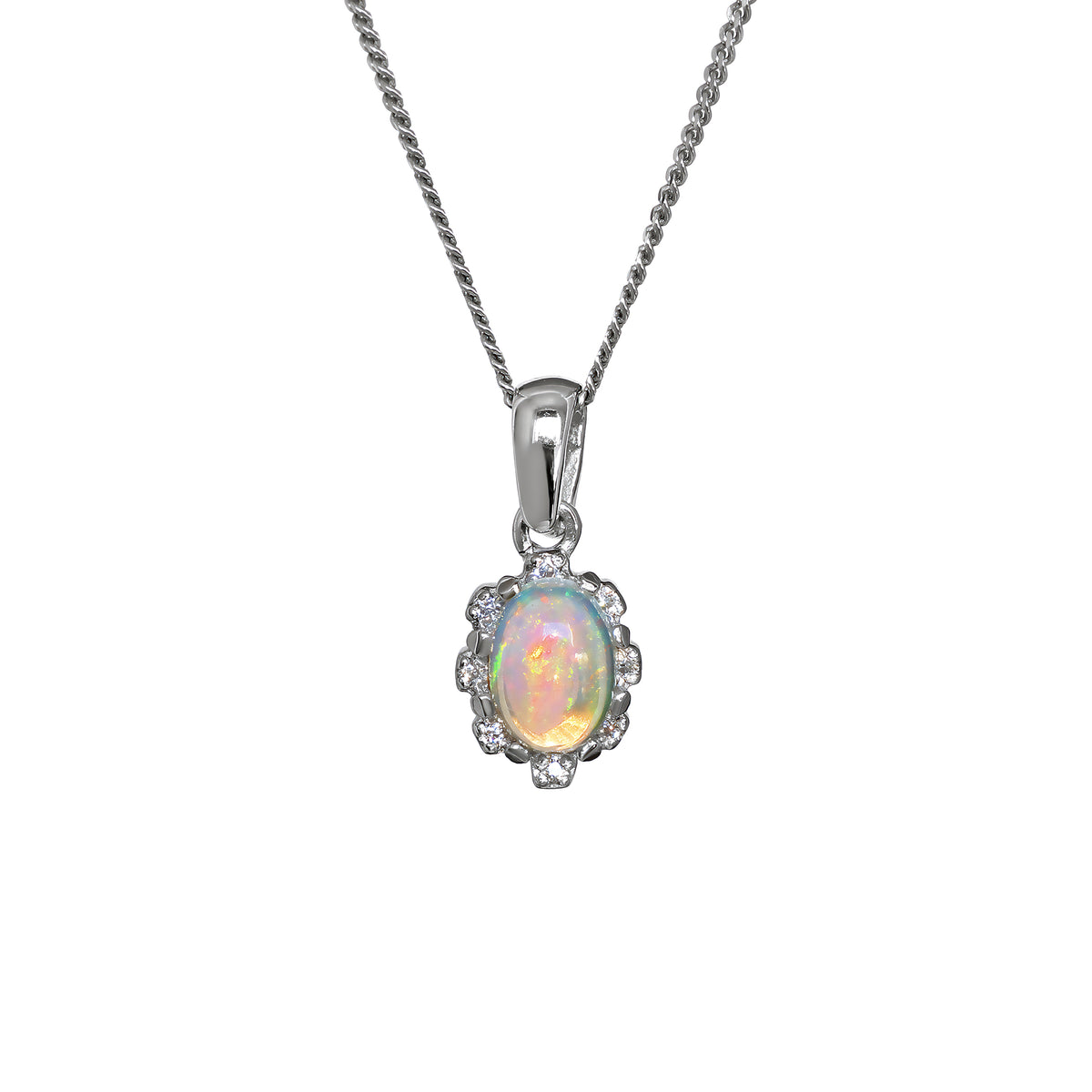 A product photo from  showing a silver Ethiopian rainbow opal pendant on a fine twist chain against a white background. The vertically-oriented, oval opal flashes with fiery orange, yellow, and green tones. It is secured by four discreet claws and surrounded by a scalloped, floral-inspired halo set with small, glittering white accent stones. The pendant hangs from a polished, classic tapered silver bail.