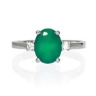 A product photo of a dainty and elegant silver ring with a stunning trio of green onyx and moissanites sitting against a white background. The large centre stone is hugged by two smaller circular white moissanites on either side.