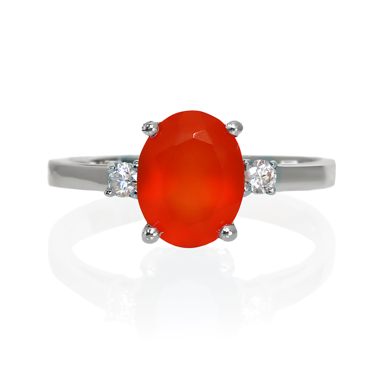A product photo of a dainty and elegant silver ring with a stunning trio of carnelian and moissanites sitting against a white background. The large centre stone is hugged by two smaller circular white moissanites on either side.