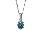 A product photo of a cabochon moss agate set in solid sterling silver suspended by a silver chain over a white background. The smooth cabochon moss agate displays cloudy green inclusions, and is framed by flowery sterling silver detailing.