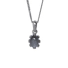 A product photo of a cabochon grey moonstone set in solid sterling silver suspended by a silver chain over a white background. The smooth cabochon moonstone is framed by flowery sterling silver detailing.