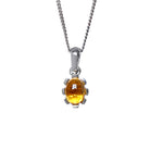 A product photo of a cabochon purple citrine set in solid sterling silver suspended by a silver chain over a white background. The smooth cabochon citrine is framed by flowery sterling silver detailing.