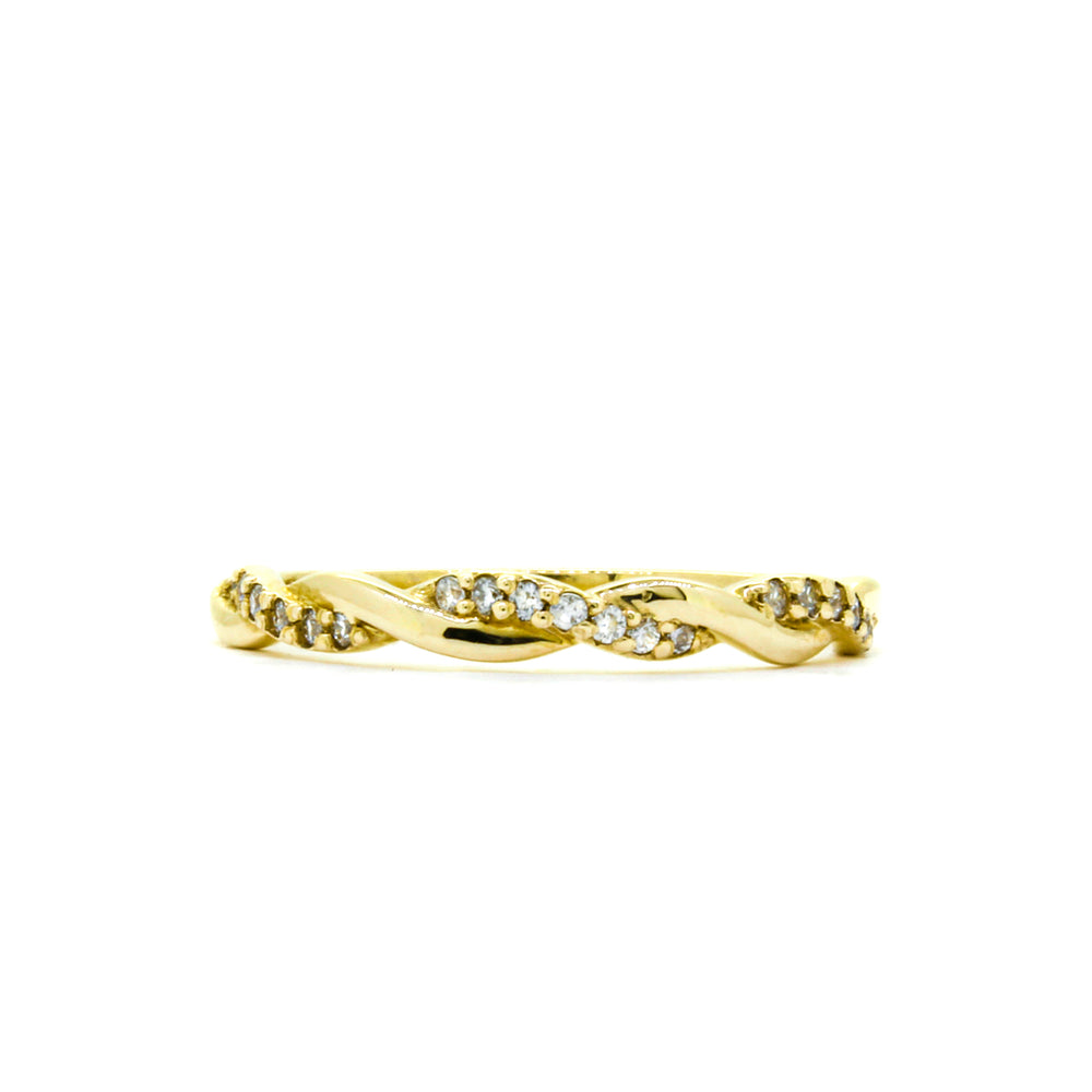 A product photo of a twine-shaped half-eternity moissanite ring in 9k yellow gold sitting on a clear white background. Two slim bands twist around one another like a wreathe, one smooth yellow gold, the other detailed with embedded moissanite jewels, both merging into one band halfway along the ring's length.