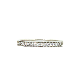 
            
                Load image into Gallery viewer, A product photo of a half eternity moissanite ring in 9k white gold sitting on a clear white background. two flat circular bands hug the top and bottom of the central band embedded with dazzling moissanite gems, all the way around.
            
        