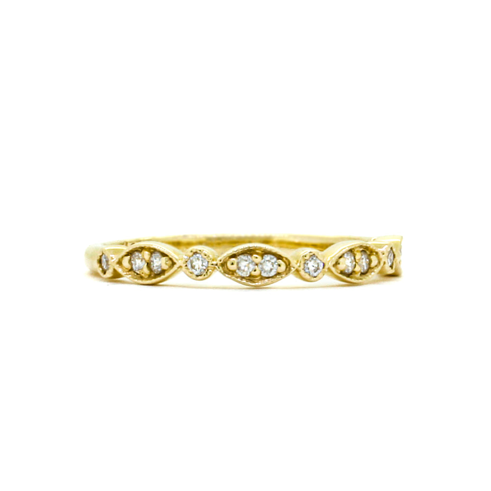 A product photo of an ornate moissanite ring in 9k yellow gold. Oval gold frames adorned with two small moissanite gems each alternate with circular gold frames adorned with singular moissanite gems and make up the ring for about half of its length before smoothing out into a simple rounded yellow gold band.