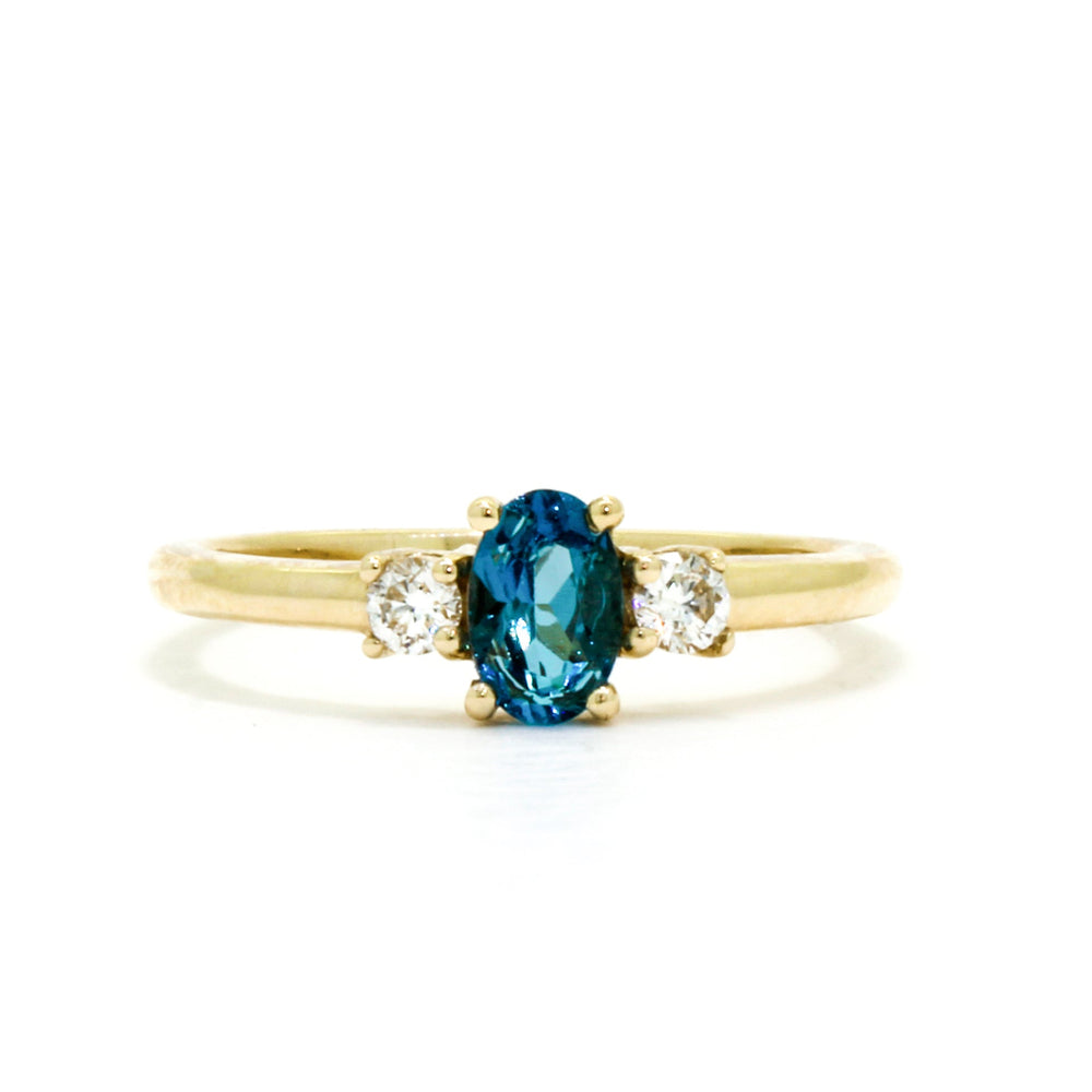 
            
                Load image into Gallery viewer, A dainty and elegant golden ring with a stunning trio of topaz and diamonds.
            
        
