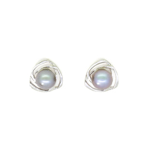 A product photo of a ornate steel grey pearl earring studs with detailed white gold backs on a white background.