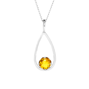 A product photo of a silver pendant with an circle-cut citrine centre stone suspended by a silver chain against a white background. The circular citrine stone rests at the bottom of a silver frame in the shape of a teardrop. The citrine jewel is almost honey-coloured, reflecting a warm orangey yellow colour across its multi-faceted surface.