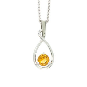 A product photo of a silver pendant with a vibrant orange centre stone. The stone sits at the base of a silver teardrop shape, which curves elegantly as it flows towards the base. The pendant is suspended by a silver chain against a white background.