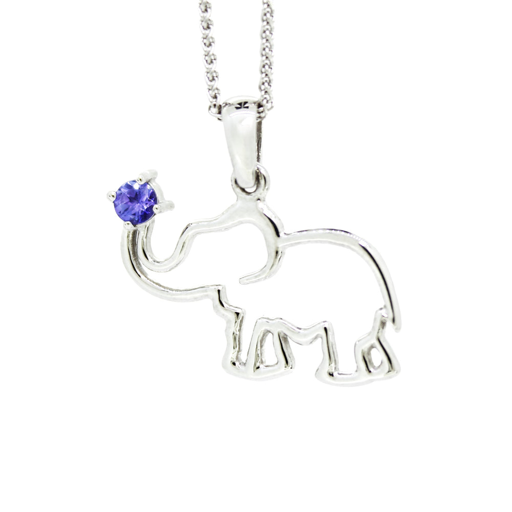 A product photo of a silver pendant in the shape of an African elephant with a tanzanite centre stone at the end of his trunk. The pendant is suspended by a silver chain against a white background.